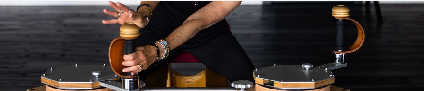 Close-up of hands guiding the GYROTONIC handle units