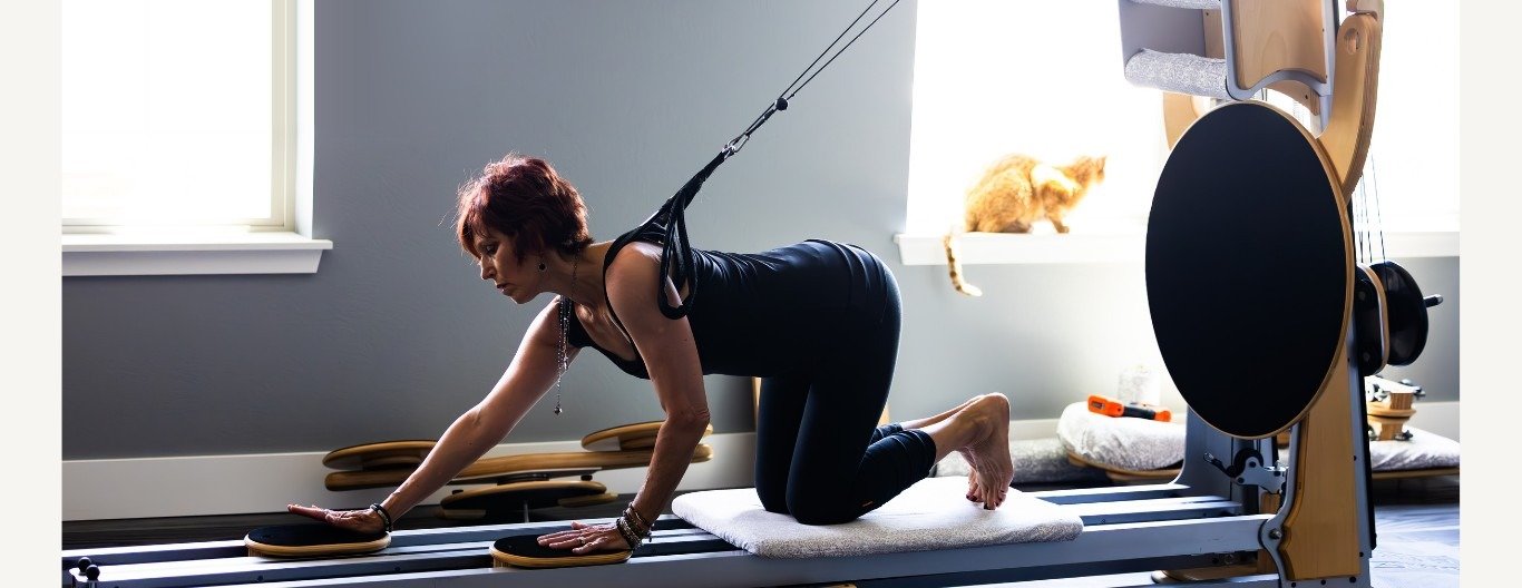 A client moving on the GYROTONIC equipment in the sunlit bodySpan studio